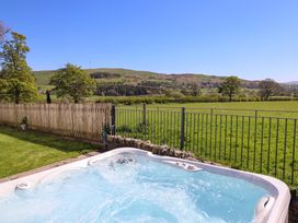 An outdoor area with a hot tub and view of the countryside at Cefn Nannau near Ty-nant Cerrigydrudion