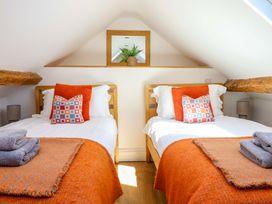 A bedroom with two beds and a mirror shelf at Cefn Nannau Ty-nant near Cerrigydrudion