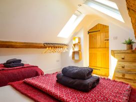 A bedroom with towels on beds and a wooden door at Cefn Nannau Ty-nant near Cerrigydrudion