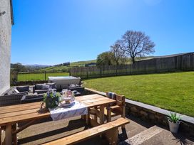 An outdoor space with a table and chairs at Cefn Nannau Ty-nant near Cerrigydrudion