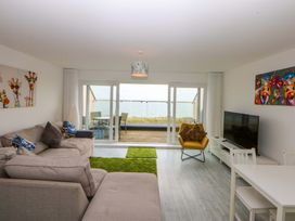 A living room with a sofa and television at Welymora in Pwllheli