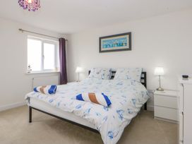 A bedroom with a bed and lamp at Welymora in Pwllheli