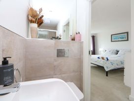 A bathroom with a sink and a view of a bedroom at Welymora in Pwllheli