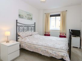 A bedroom with a bed and nightstand at Welymora in Pwllheli