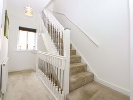 A staircase and window in a hallway at Welymora Pwllheli