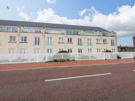 A building with balconies and a fence at Welymora in Pwllheli