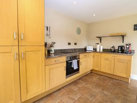 A kitchen with cabinets, oven, toaster, kettle at Tilly's Retreat in Hunstanton