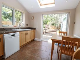 A kitchen with sink and table at Tilly's Retreat in Hunstanton