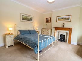 A bedroom with a bed and bedside tables at Tilly's Retreat in Hunstanton