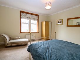 A bedroom with a bed and wardrobe at Tilly's Retreat in Hunstanton