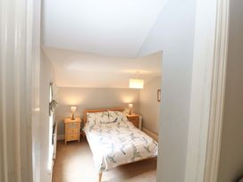 A bedroom with a bed and bedside tables at Tilly's Retreat in Hunstanton