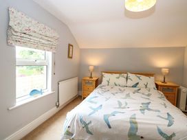 A bedroom with a double bed and bedside tables at Tilly's Retreat in Hunstanton