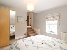 A bedroom with a bed and wardrobe at Tilly's Retreat in Hunstanton