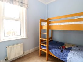 A bedroom with a bunk bed and window at Tilly's Retreat in Hunstanton