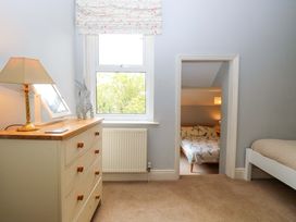 A bedroom with a bed and dressing table at Tilly's Retreat in Hunstanton