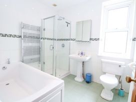A bathroom with a shower, bathtub, and sink at Tilly's Retreat in Hunstanton