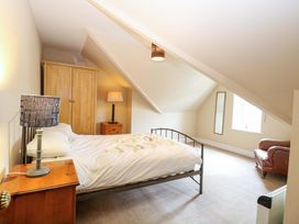 A bedroom with a bed and wardrobe at Tilly's Retreat in Hunstanton