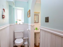 A bathroom with a toilet and sink at Tilly's Retreat in Hunstanton