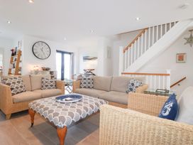 A living room with sofas and a coffee table at Seaspell Beach House in Constantine Bay
