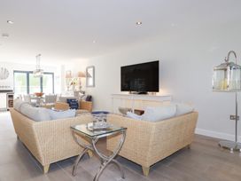 A living room with a television and seating area at Seaspell Beach House in Constantine Bay
