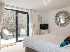 A bedroom with a bed and a mirror at Seaspell Beach House in Constantine Bay