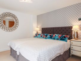 A bedroom with a bed and nightstand at Seaspell Beach House in Constantine Bay
