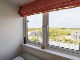 A window with a curtain and decorative item at Seaspell Beach House in Constantine Bay