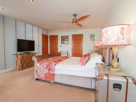 A bedroom with a bed and television at Seaspell Beach House in Constantine Bay