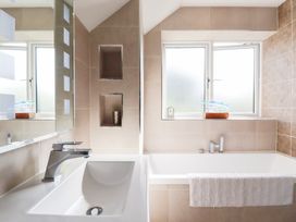 A bathroom with a sink and bathtub at Seaspell Beach House Constantine Bay