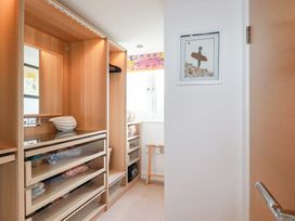 A dressing room with shelves and a mirror at Seaspell Beach House in Constantine Bay
