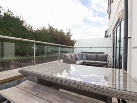 An outdoor space with a table and sofa at Seaspell Beach House in Constantine Bay