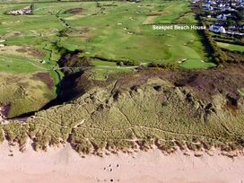 An aerial view of a beach and golf course at Seaspell Beach House in Constantine Bay