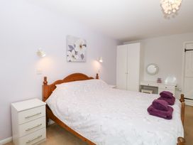 A bedroom with a bed and nightstand at Lowbrook Cottage Dickleburgh near Diss