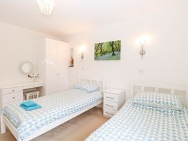 A bedroom with two single beds and a desk at Lowbrook Cottage Dickleburgh near Diss