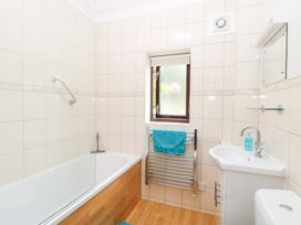 A bathroom with a bath tub and sink at Lowbrook Cottage Dickleburgh near Diss
