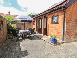 An outdoor seating area with table and chairs at Lowbrook Cottage Dickleburgh near Diss