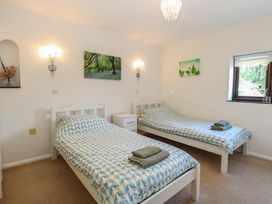 A bedroom with two beds and artwork at Lowbrook Cottage Dickleburgh near Diss