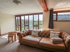 A living room with a sofa and coffee table at Glanyrafon in St Harmon