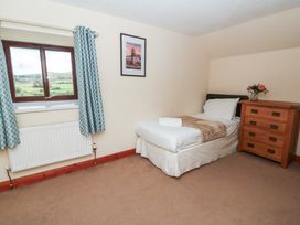 A bedroom featuring a single bed and a chest of drawers at Glanyrafon in St Harmon