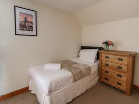A bedroom with a single bed and a chest of drawers at Glanyrafon in St Harmon