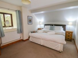 A bedroom with a bed and window at Glanyrafon in St Harmon