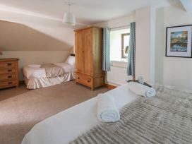 A bedroom with beds and furniture at Glanyrafon in St Harmon
