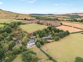 A landscape with houses and fields at Glanyrafon Bungalow in St Harmon