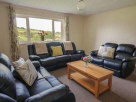 A living room with sofas and a coffee table at Glanyrafon Bungalow St Harmon