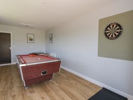 A game room with a pool table and a dartboard at Glanyrafon Bungalow St Harmon