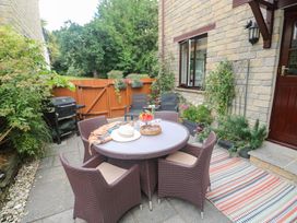 An outdoor dining area with a table and chairs at Tranquility in Falmouth