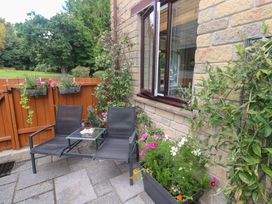 An outdoor area with chairs and a table at Tranquility in Falmouth