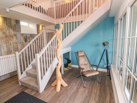 An entrance hall with a staircase and a chair at Silvermine House, Charlestown