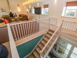 A living room with sofas and a television at Silvermine House in Charlestown