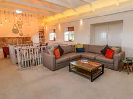 A living room with a sofa, coffee table, and bookshelf at Silvermine House in Charlestown